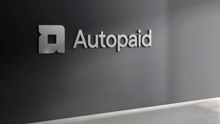 Autopaid wordmark and symbol in a delivered brand application mockup.